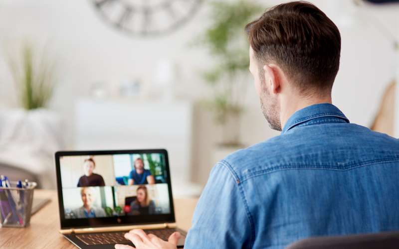 A man at a home desk on a video call
